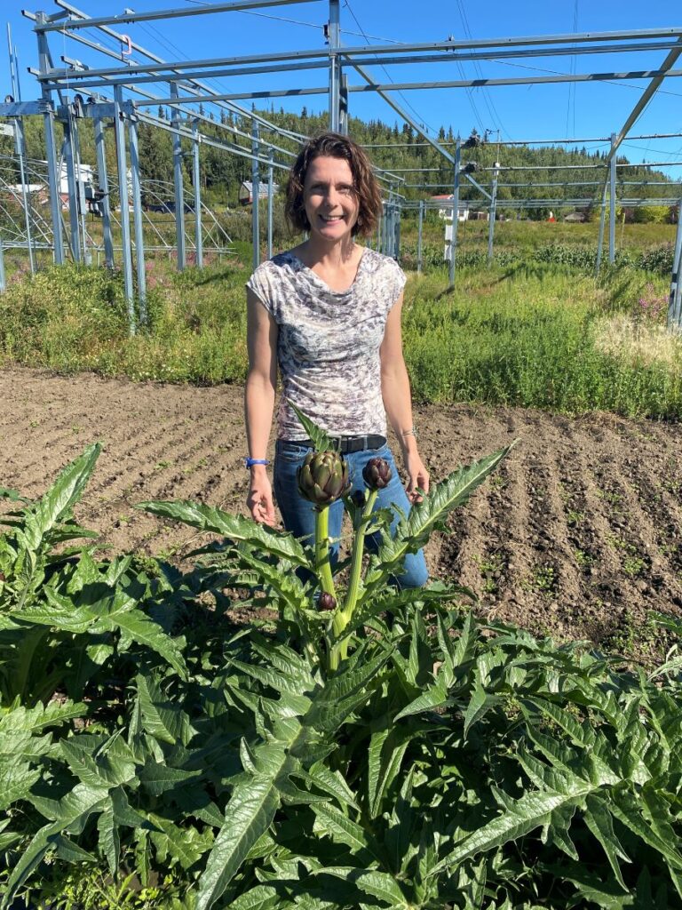 Heidi Rader in front of an artichoke.