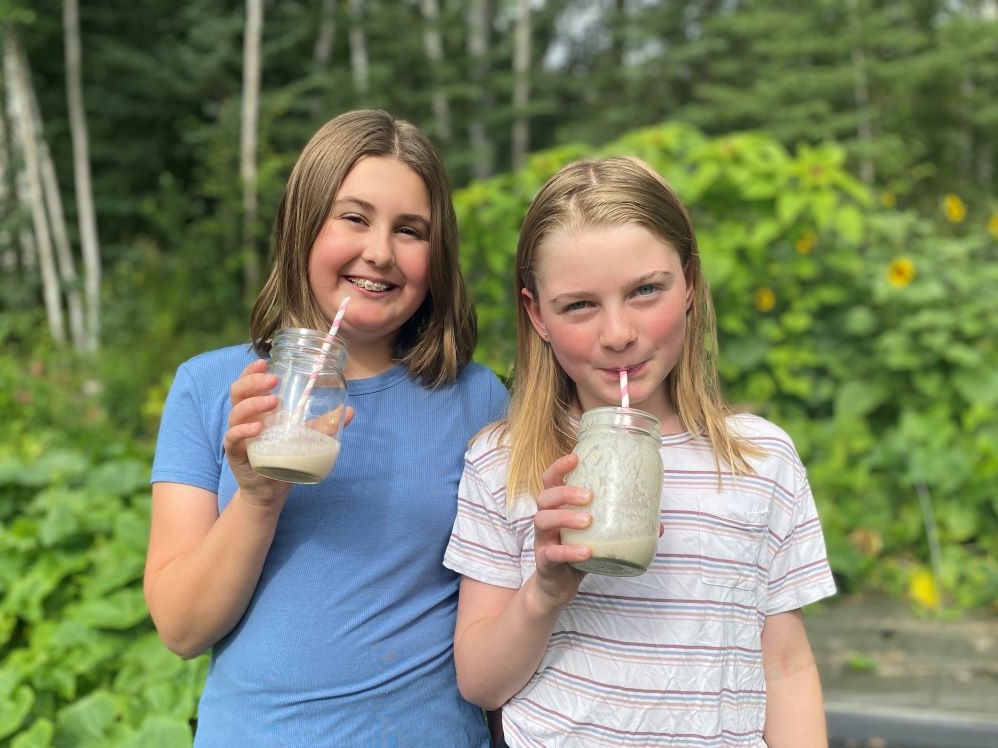 Two girls drinking smoothies