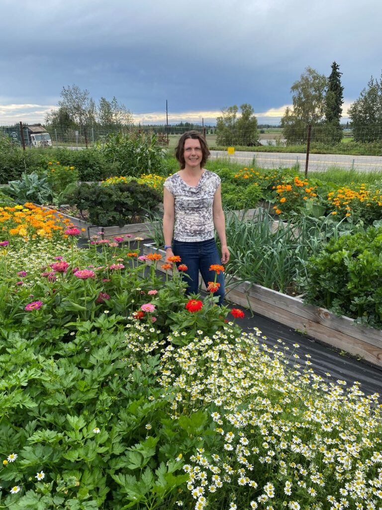 heidi in front of raised bed garden